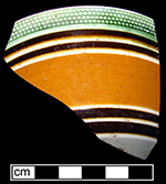 Bowl banded in orange and black, with green-glazed rouletting along rim - from 18BC27.